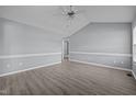 Spacious living room with vaulted ceilings, neutral paint, modern ceiling fan, and stylish gray laminate flooring at 161 Bridgewater Dr, Erwin, NC 28339