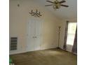 Bright bedroom with a ceiling fan, double closet, and natural light from the window at 221 Hickory Glen Ln, Durham, NC 27703