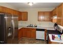 Kitchen with stainless steel refrigerator and appliances, plus wooden cabinets at 221 Hickory Glen Ln, Durham, NC 27703