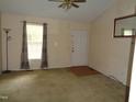 Inviting living room with neutral walls, ceiling fan, and natural light from the window at 221 Hickory Glen Ln, Durham, NC 27703