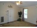 Cozy living room featuring neutral tones, a ceiling fan, and natural light from the window at 221 Hickory Glen Ln, Durham, NC 27703