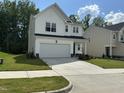 Well maintained two-story home featuring a freshly paved driveway and manicured lawn at 2417 Tobacco Root Dr, Raleigh, NC 27616