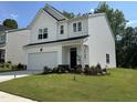 Charming home with an attached garage, neatly trimmed lawn, and flower beds at 2417 Tobacco Root Dr, Raleigh, NC 27616