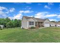 Exterior view of the house showing the expansive lawn, landscaping, and a fenced-in yard for privacy at 272 W Gennessee Dr, Zebulon, NC 27597