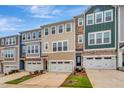 A row of inviting townhomes feature coordinated color palettes and well-manicured landscaping at 2735 Hunter Woods Dr # 571, Apex, NC 27502