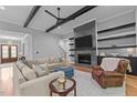 Cozy living room with a modern fireplace, a large sectional sofa, and stylish decor at 310 Hidden Lake Dr, Youngsville, NC 27596