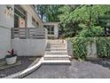 Close up of the home's entrance with brick steps, inviting landscape, and manicured garden at 3205 Dell Dr, Raleigh, NC 27609