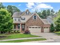 Beautiful two-story home featuring a stone facade, attached garage, and landscaped front yard at 3312 Flat River Dr, Durham, NC 27703