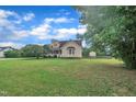 Expansive lawn surrounds a charming home featuring a lovely yard, promising outdoor enjoyment and curb appeal at 35 Stratton Ct, Youngsville, NC 27596