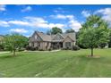 Brick home showcasing a large, well-maintained lawn with mature trees and attractive landscaping at 3728 Marwick Ct, Wendell, NC 27591