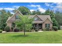 A stately brick home with well-kept lawn and mature trees, presenting a picturesque curb appeal at 3728 Marwick Ct, Wendell, NC 27591