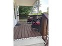 Relaxing front porch furnished with wicker chairs and a wooden floor at 40 Bait Rd, Dunn, NC 28334