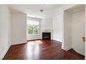 Bright living room featuring a fireplace, large windows, and hardwood floors at 400 W Rosemary St # 114, Chapel Hill, NC 27516