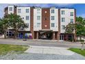 Street view of white and red brick building with trees and street-level access at 400 W Rosemary St # 114, Chapel Hill, NC 27516