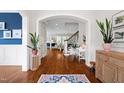 Inviting foyer with hardwood floors, plants, and stylish decor seamlessly blending into a bright, open-concept living space at 4729 Adler Pass, Raleigh, NC 27612