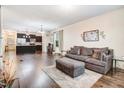 Spacious living room with hardwood floors and modern decor open to kitchen at 51 Balboa Pkwy, Clayton, NC 27520