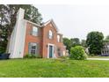 Charming two-story brick home with teal shutters and well-maintained lawn at 5200 Fieldwood Ct, Raleigh, NC 27616