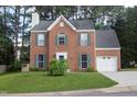 Charming two-story brick home with teal shutters and a well-manicured lawn at 5200 Fieldwood Ct, Raleigh, NC 27616