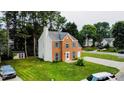 Charming two-story home with brick and siding, teal shutters, and a well-manicured lawn at 5200 Fieldwood Ct, Raleigh, NC 27616