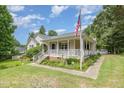 Charming single Gathering home featuring well maintained yard, landscaping and inviting front porch at 559 Blue Pond Rd, Clayton, NC 27520