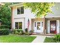 Charming exterior view of a two-story home with a well-kept lawn and an inviting front door at 6021 Dixon Dr, Raleigh, NC 27609