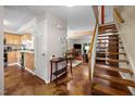 Spacious living area with a staircase, seamless blending of kitchen, dining, and living spaces at 6021 Dixon Dr, Raleigh, NC 27609