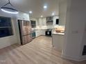 Renovated kitchen with stainless steel appliances, new countertop, and modern white cabinets at 620 Red Carriage Ave, Durham, NC 27704