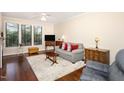 Comfortable living room with large windows, hardwood floors, and ceiling fan at 7250 Nc 751 Highway, #1205, Durham, NC 27707