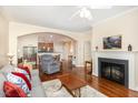 Cozy living room featuring a fireplace, archway to the kitchen, and hardwood floors at 7250 Nc 751 Highway, #1205, Durham, NC 27707