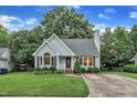 Charming single-story home with tidy landscaping, blue siding, and a well manicured lawn at 8 Great Oak Ct, Durham, NC 27713