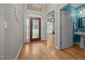 Entryway with hardwood floors, a decorative front door, and a view of the adjacent living spaces at 8116 Mosby Way, Willow Springs, NC 27592