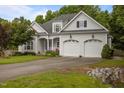 Charming two-story home with a well-manicured lawn, flowering plants, and a two car garage at 8116 Mosby Way, Willow Springs, NC 27592