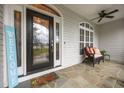 Inviting front porch with decorative door and stone flooring with an adjacent bench at 8116 Mosby Way, Willow Springs, NC 27592