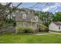 Quaint two-story home with dormer windows, a welcoming entrance, and a verdant front yard at 816 Kimpton Ct, Fuquay Varina, NC 27526