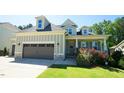 Charming home boasts a well-manicured lawn, attached garage, and welcoming entrance at 966 Airedale Trl, Garner, NC 27529