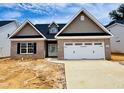 New brick home with a two-car garage, shingle and stone accents, and a well-manicured lawn at 1079 Fairhaven Dr # 50, Mebane, NC 27302
