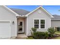 Well-kept front entrance with large window, storm door, and tidy landscaping features at 119 Yadkin St, Clayton, NC 27520