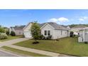 Inviting one-story home with mature landscaping, healthy green lawn, and a paved driveway at 119 Yadkin St, Clayton, NC 27520