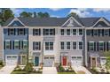 Townhome exteriors showing colorful siding and black framed windows at 1359 Chowan Ave, Durham, NC 27713