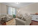 Comfortable living room featuring hardwood floors, cozy seating, and natural light from a large window at 136 Garden Retreat Dr, Garner, NC 27529