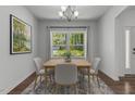 Cozy dining room featuring a square table with four chairs and a bright window view at 1414 Arena Ln, Fuquay Varina, NC 27526