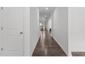 Bright hallway with hardwood floors leading to a sunlit window at the far end at 1414 Arena Ln, Fuquay Varina, NC 27526
