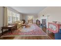 Bright living room featuring hardwood floors, a fireplace, and a large window overlooking the yard at 1732 Edgewood Ave, Burlington, NC 27215