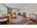 Cozy living room featuring a fireplace, hardwood floors, and ample space for relaxation at 1732 Edgewood Ave, Burlington, NC 27215