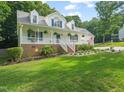 Beautiful two-story home with a welcoming front porch and lush landscaping at 178 Palmer Dr, Clayton, NC 27527