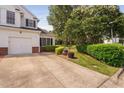 Charming home featuring a well-maintained lawn, mature trees, and a paved driveway at 2 Lake Village Dr, Durham, NC 27713