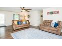 Inviting living room with hardwood floors, comfortable seating, and a stylish area rug at 2120 Northcrest Dr, Elon, NC 27244