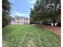 Expansive backyard with well-maintained lawn, mature trees, and potential for outdoor enjoyment at 2228 Cedar Grove Dr, Durham, NC 27703