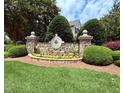 Stone entrance sign for Alexander Crossing community featuring lush landscaping and a welcoming atmosphere at 2228 Cedar Grove Dr, Durham, NC 27703