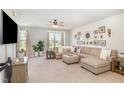 Inviting living room features a decorative wall, plush seating, neutral tones, and ample natural light at 248 Amber Acorn Ave, Raleigh, NC 27603